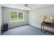 Bedroom with blue carpet, ceiling fan, and double window overlooking the yard at 2201 Colonial Oak Way, Stone Mountain, GA 30087