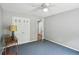 Bedroom with blue carpet and double closets, featuring a view to another room at 2201 Colonial Oak Way, Stone Mountain, GA 30087