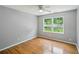 Bedroom with ceiling fan and hardwood floors featuring a large double window at 2201 Colonial Oak Way, Stone Mountain, GA 30087