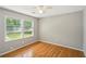 Bright bedroom with hardwood floors, offering a scenic outdoor view at 2201 Colonial Oak Way, Stone Mountain, GA 30087