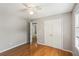 Bedroom featuring hardwood flooring, ceiling fan, closet, and an ensuite at 2201 Colonial Oak Way, Stone Mountain, GA 30087
