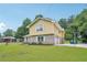 Two-story home featuring yellow siding, brickwork, and a neatly maintained lawn at 2201 Colonial Oak Way, Stone Mountain, GA 30087