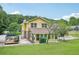 Exterior aerial view of yellow multi-story home with expansive yard and mature trees at 2201 Colonial Oak Way, Stone Mountain, GA 30087