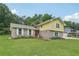 Two-story home with yellow siding and brick accent, set on a lush green lawn at 2201 Colonial Oak Way, Stone Mountain, GA 30087