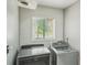Functional laundry area with modern washer and dryer and a window at 2201 Colonial Oak Way, Stone Mountain, GA 30087