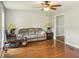 Comfortable living room with ceiling fan, hardwood floors, and neutral paint at 2201 Colonial Oak Way, Stone Mountain, GA 30087