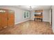 Large room with wood floors, double doors, TV and large window at 2201 Colonial Oak Way, Stone Mountain, GA 30087