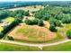 Aerial view of acreage with lovely green space, road frontage, and scattered trees at 259 Hwy 11, Social Circle, GA 30025