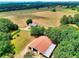 Aerial view of home, land, and large outbuilding at 259 Hwy 11, Social Circle, GA 30025