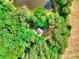Stunning aerial view of a home nestled among lush trees and a serene pond at 259 Hwy 11, Social Circle, GA 30025