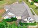 Aerial view of a large brick home showcasing well-maintained landscaping, lush greenery, and a spacious backyard at 259 Hwy 11, Social Circle, GA 30025