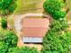 Overhead view of a rustic barn featuring a metal and shingled roof, surrounded by lush trees at 259 Hwy 11, Social Circle, GA 30025