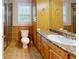Well-lit bathroom with wood cabinets, double sink, and a separate shower and toilet area at 259 Hwy 11, Social Circle, GA 30025