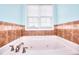 Bathroom featuring a drop-in soaking tub with tile surround and window at 259 Hwy 11, Social Circle, GA 30025