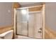 Bathroom features a shower with sliding glass doors, granite style surround, and tiled floors at 259 Hwy 11, Social Circle, GA 30025