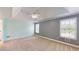 Bedroom with large windows, ceiling fan, and neutral carpeting at 259 Hwy 11, Social Circle, GA 30025