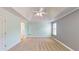 Bright and airy bedroom with tray ceiling, ceiling fan and carpet at 259 Hwy 11, Social Circle, GA 30025