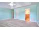 Bedroom featuring carpet and a ceiling fan with view to adjacent bathroom at 259 Hwy 11, Social Circle, GA 30025