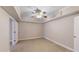 Bedroom features plush carpet, ceiling fan and tray ceiling at 259 Hwy 11, Social Circle, GA 30025