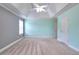 Bedroom featuring carpet and a ceiling fan with one window and two doors at 259 Hwy 11, Social Circle, GA 30025