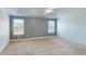 A bedroom showcasing neutral tones, two windows, carpet flooring, and a tray ceiling with ceiling fan at 259 Hwy 11, Social Circle, GA 30025