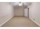 Bedroom featuring neutral carpet and a ceiling fan with an adjacent doorway at 259 Hwy 11, Social Circle, GA 30025