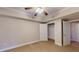 A bedroom with carpet flooring features an open closet and neutral colored walls at 259 Hwy 11, Social Circle, GA 30025