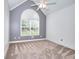 Bedroom with vaulted ceiling, a ceiling fan, and large arched window at 259 Hwy 11, Social Circle, GA 30025