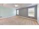 Bedroom with large windows, ceiling fan, and neutral carpeting at 259 Hwy 11, Social Circle, GA 30025
