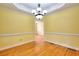 Open dining room showcasing hardwood floors, stylish trim work, and a contemporary chandelier at 259 Hwy 11, Social Circle, GA 30025