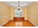 Charming dining room boasting hardwood floors, crown molding, and built-in storage beneath a window at 259 Hwy 11, Social Circle, GA 30025