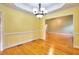 Bright dining room featuring hardwood floors, elegant molding, and a modern chandelier at 259 Hwy 11, Social Circle, GA 30025