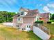 Back exterior of a brick house featuring a walkout basement, patio, and lush green lawn at 259 Hwy 11, Social Circle, GA 30025