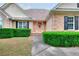 Charming brick home exterior with lush, manicured landscaping and inviting front entrance at 259 Hwy 11, Social Circle, GA 30025