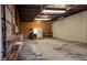 Interior of garage with roll-up door, workbench, and exposed ceiling, ready for your vehicles at 259 Hwy 11, Social Circle, GA 30025