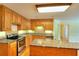 Well-equipped kitchen featuring oak cabinets, granite countertops, stainless steel appliances, and a central island at 259 Hwy 11, Social Circle, GA 30025