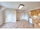Open-concept kitchenette with wood cabinets and vinyl floors at 259 Hwy 11, Social Circle, GA 30025