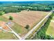 Expansive land featuring a home and surrounding trees, offering a picturesque country setting with road access at 259 Hwy 11, Social Circle, GA 30025
