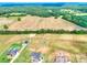 Aerial view showcasing expansive land with modern homes, pool, outbuildings and verdant landscapes at 259 Hwy 11, Social Circle, GA 30025