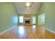 Spacious living room with a fireplace, vaulted ceiling, hardwood floors, and ample natural light at 259 Hwy 11, Social Circle, GA 30025