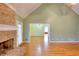 Bright living room with hardwood flooring and brick fireplace at 259 Hwy 11, Social Circle, GA 30025