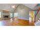 A living room features hardwood flooring, a brick fireplace, and multiple entryways at 259 Hwy 11, Social Circle, GA 30025