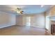 Spacious carpeted living room with fireplace and sliding doors to outdoors at 259 Hwy 11, Social Circle, GA 30025