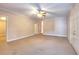 Spacious living room with neutral carpeting and a traditional ceiling fan at 259 Hwy 11, Social Circle, GA 30025