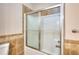 Bathroom shower with framed glass sliding door and tile surround at 259 Hwy 11, Social Circle, GA 30025