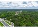 Wide aerial shot of a town surrounded by lush forest and a highway on the edge of the frame at 4721 W Lakeshore Dr, Acworth, GA 30101