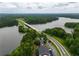 Bird's eye view of a lake with a bridge, surrounded by lush greenery and trees at 4721 W Lakeshore Dr, Acworth, GA 30101
