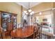 Formal dining room features an elegant chandelier, wainscoting, and rich wood furniture at 4721 W Lakeshore Dr, Acworth, GA 30101
