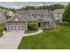 Charming home features a two-car garage and a well-manicured front lawn and an inviting front porch at 4721 W Lakeshore Dr, Acworth, GA 30101