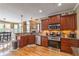 Gourmet kitchen featuring stainless appliances, granite countertops, and a view of the breakfast nook at 4721 W Lakeshore Dr, Acworth, GA 30101